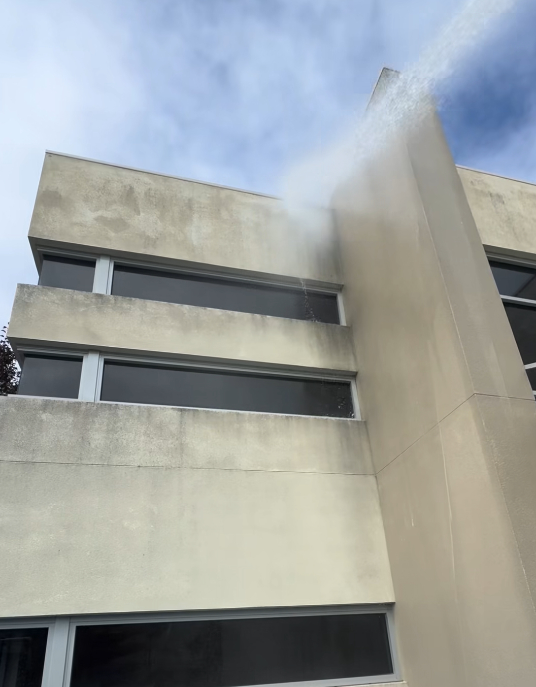 Soft washing a stained commercial building exterior
